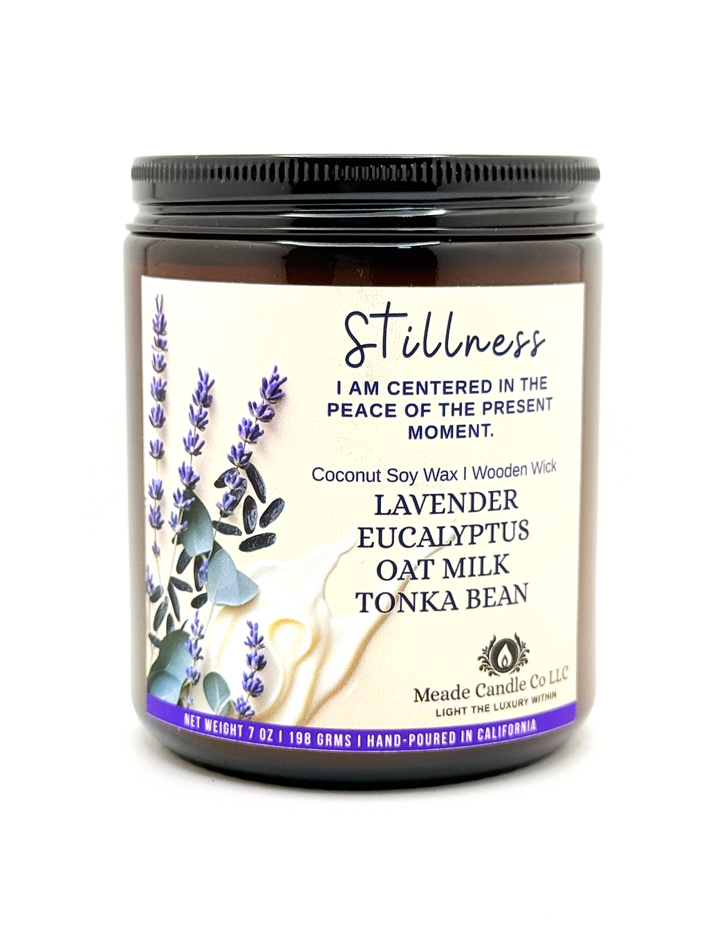 Scented candle jar with 'Stillness' label.