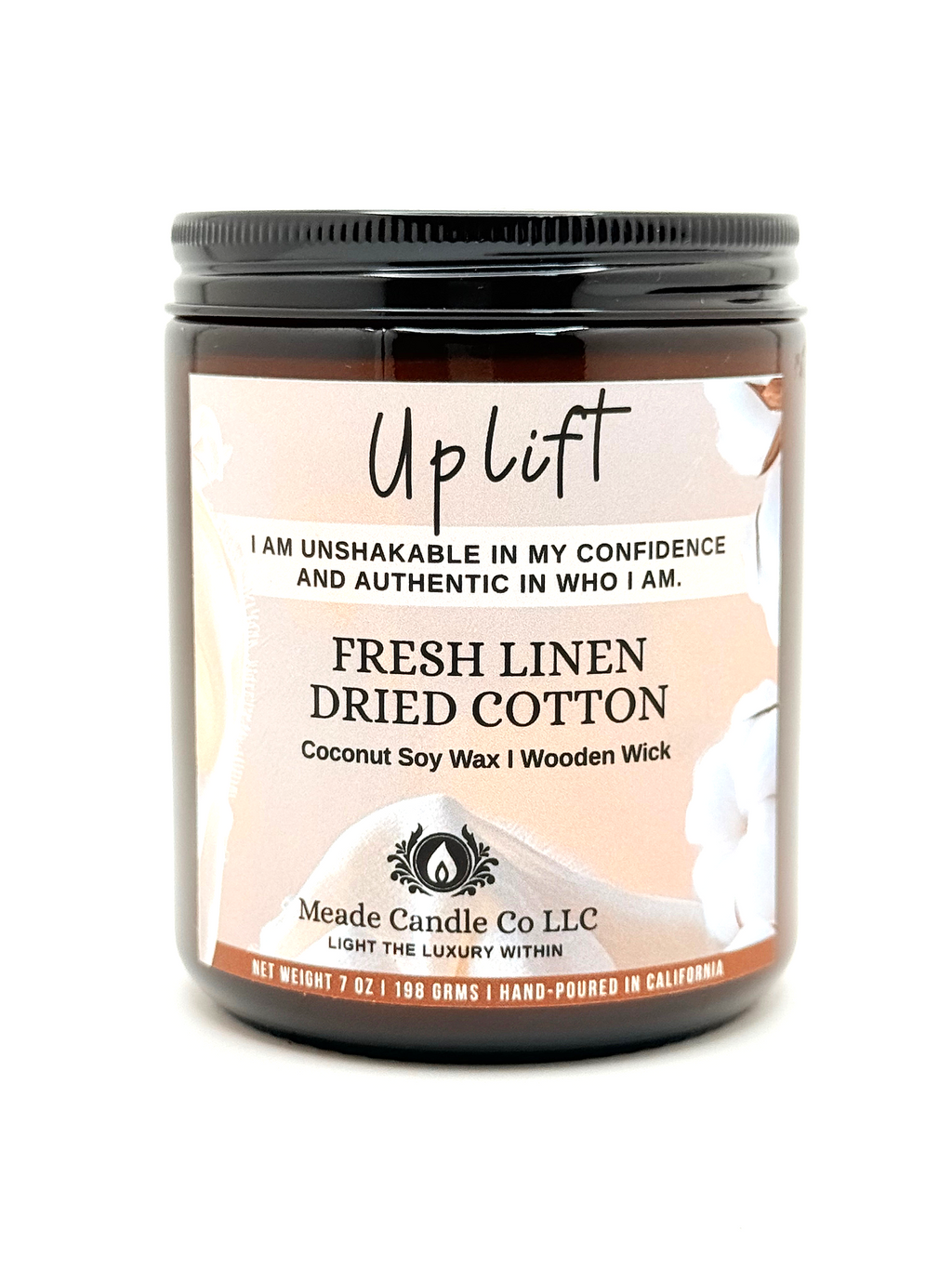 Scented candle jar labeled 'Uplift'.