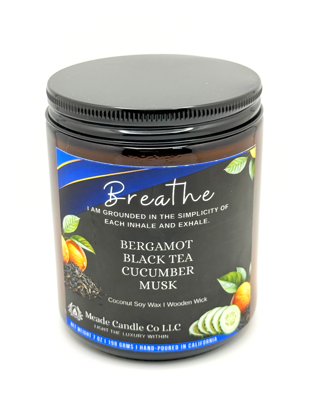 Candle jar with label 'Breathe' featuring bergamot, black tea, cucumber, and musk scent.